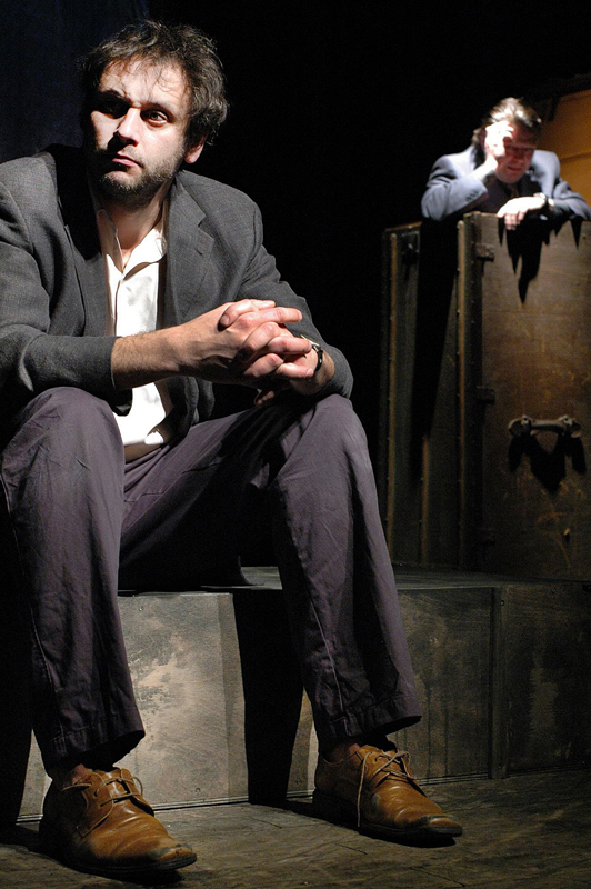 Igor Chmela sedící na schodě, v pozadí Leoš Noha opřený o vysokou bednu