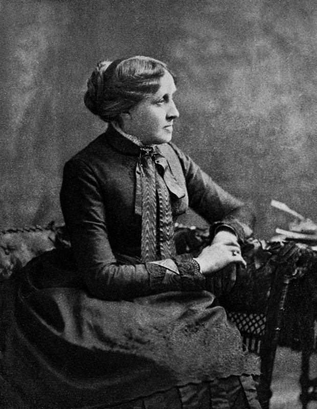 sedící Louisa May Alcottová