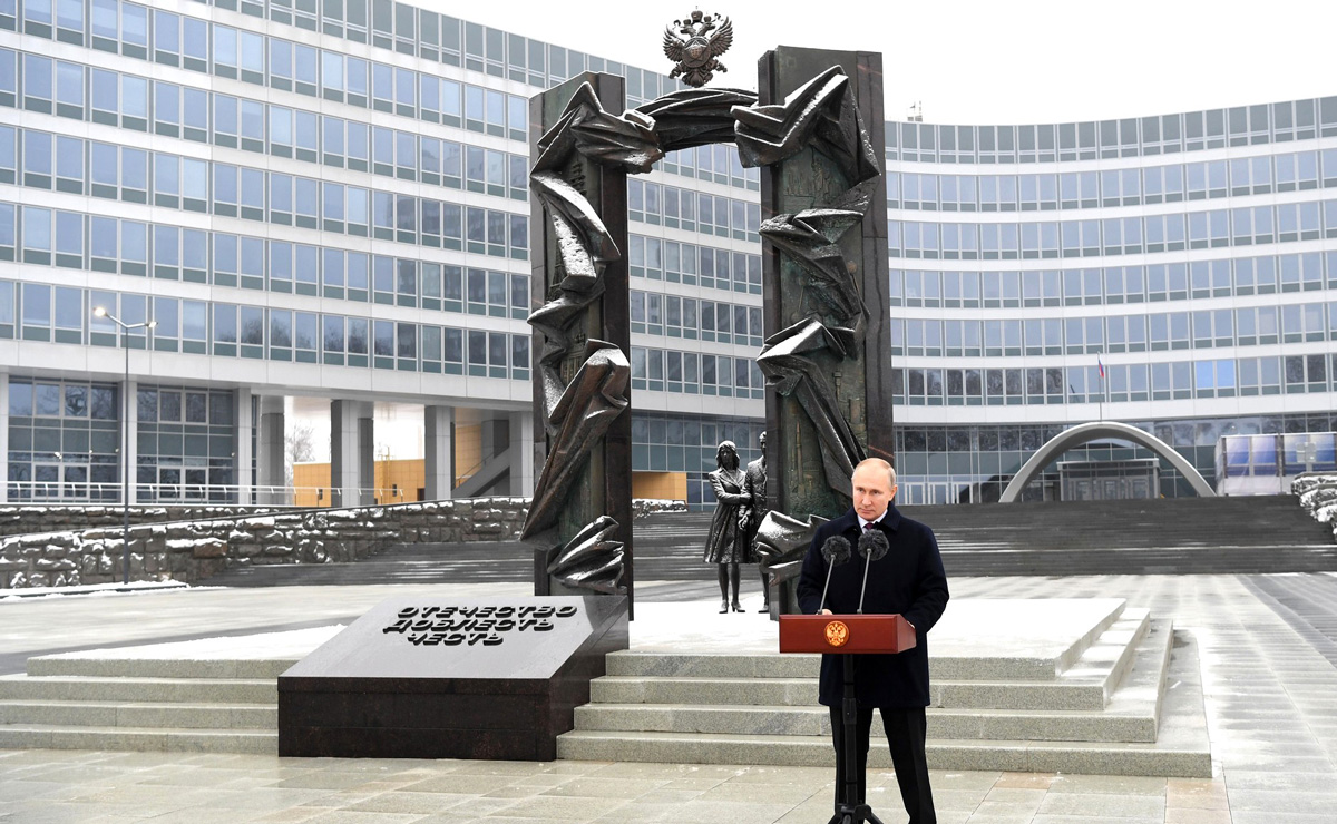 Vladimír Putin u řečnického pultíku, v pozadí pomník