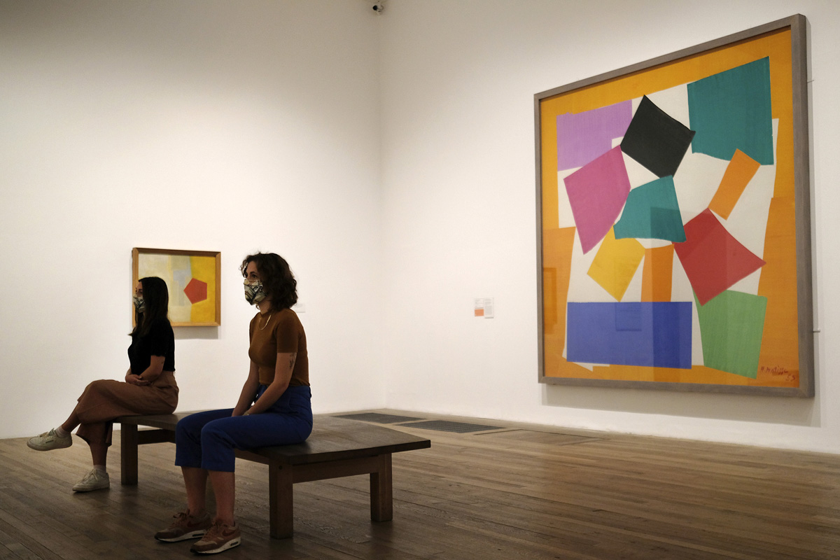 dvě návštěvnice s rouškami sedí v galerii